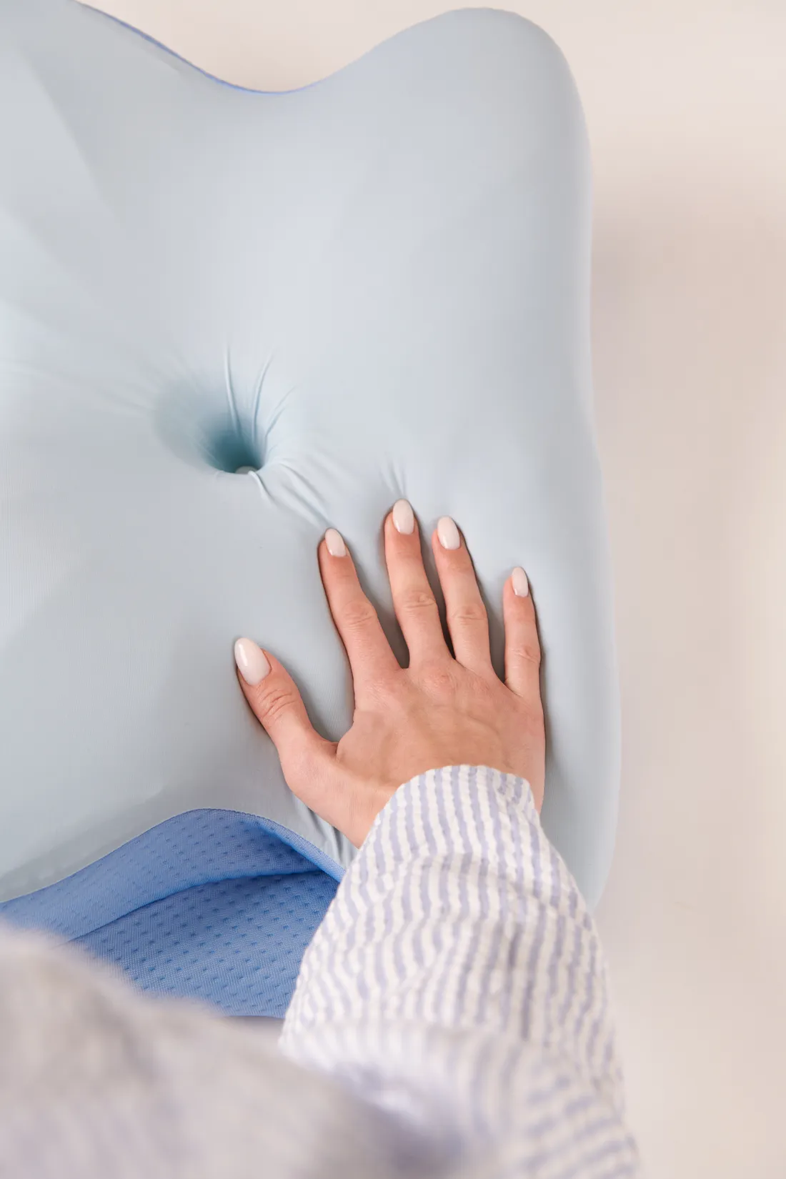A hand pressing into the high-density memory foam showing how it molds